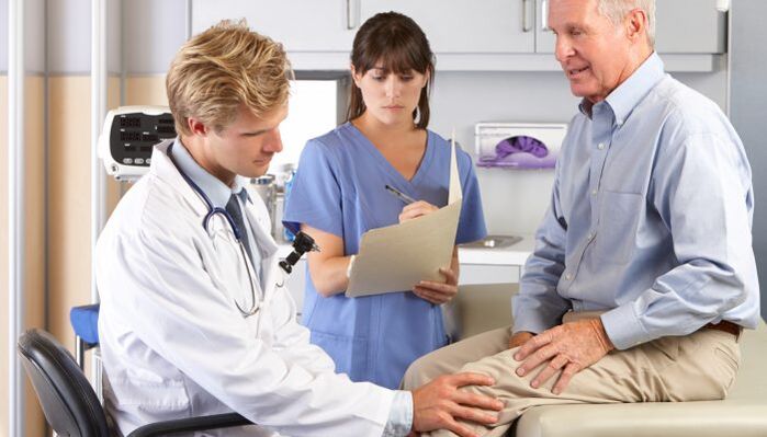 Doctor checking knee joint