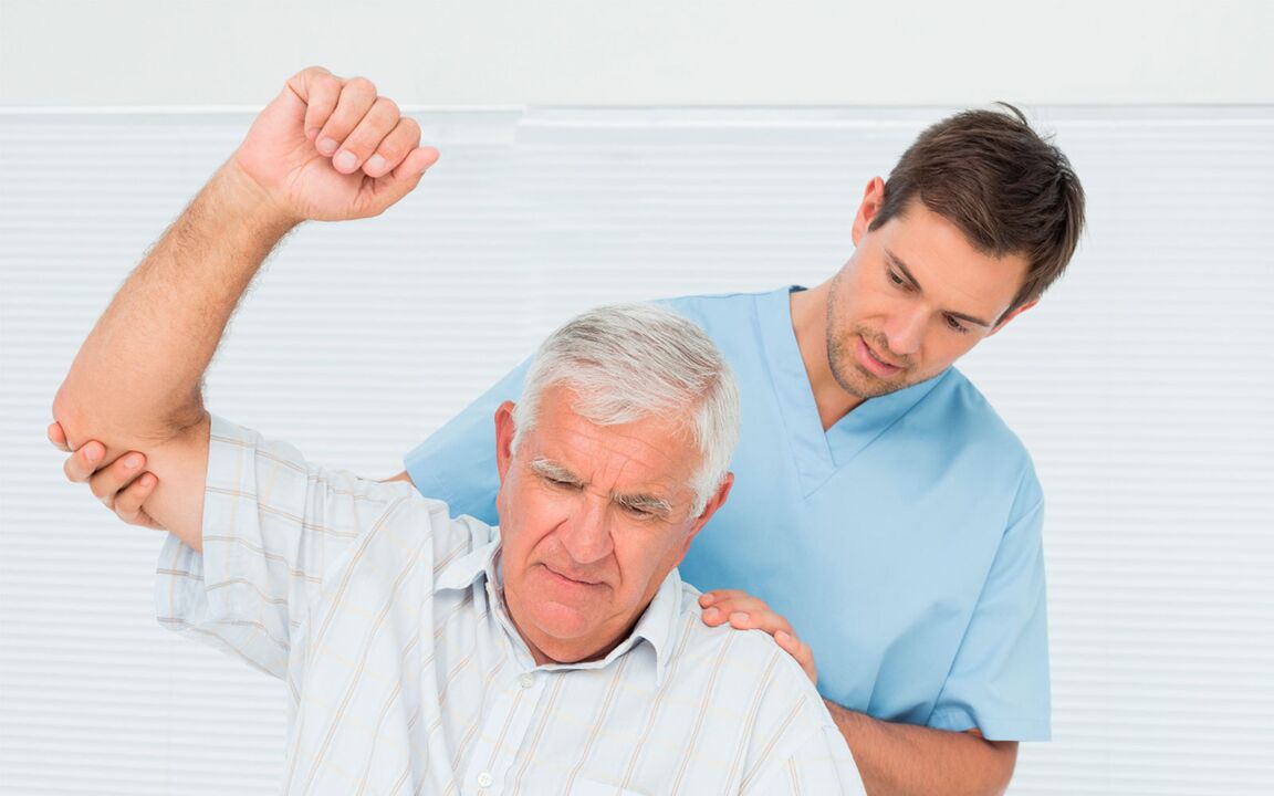 Doctor examining shoulder joint patient